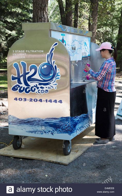 Woman filling reusable water bottle with drinking water from H2O buggy (mobile water station) at event in city park Water Refilling Station Design, Water Station Ideas, Water Dispenser Design, Franchise Design, Water Business, Save Water Poster, Water Bottle Label Design, Water Facts, Water Station