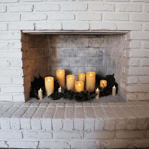 Confused about how to decorate your fireplace? These simple ways to decorate a fireplace with flameless candles are easy to do & look great! Led Candles In Fireplace, Fake Fireplace Logs With Lights, Fireplace Candle Ideas, Candles In Fireplace Christmas, Fireplace Candle Decor, Fireplace Candles Inside Hearth, Fireplace With Candles Inside, Empty Fireplace Decor, Fireplace Candles Inside