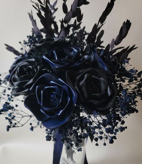 7 Beautiful leather roses. With  greenery accents. 3 black leather, 4 deep sea blue leather roses in this beautiful arrangement that lasts forever.    Stem has criss cross leather ribbon, finishes off with black leather and navy blue satin ribbons...  gorgeous bouquet  💐 Navy Blue And Black Wedding Theme, Black And Blue Roses Bouquet, Navy Blue And Black Wedding, Black And Blue Wedding Theme, Dark Blue Roses Bouquet, Blue And Black Roses, Black Blue Silver Bouquet, Blue And Black Flowers Aesthetic, Flowers Anniversary