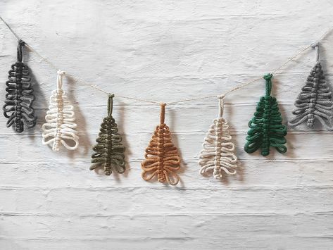 "Hang these super cute macrame Christmas tree garland as a soft nordic, swedish farmhouse or rustic decoration - the perfect finishing touch for your holiday decor. Beautiful wall decoration can make your home more beautiful and cozy.  More holiday decor: https://www.etsy.com/shop/DivaDessiva?ref=shop-header-name&listing_id=1083939734&from_page=listing&section_id=30070512 The tree ornaments are about 6 inch/15 cm in size. They are strung on twine thread, are not fixed to it and can be moved at y Christmas Tree Yarn Garland, Rustic Fireplace Mantels Decorations, Christmas Tree Yarn, Yarn Garland, Rustic Fireplace Mantel, Macrame Christmas Tree, Macrame Garland, Rustic Fireplace Mantels, Rustic Fireplace