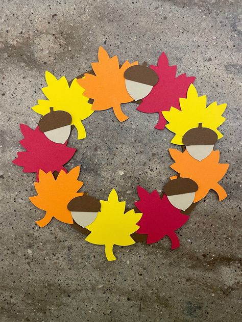 "This adorable fall wreath will make a great fall decoration for your home. Let your child arrange the wreath in whichever way they like best! :) I will send you all the pieces you need cut out of colored cardstock...all you need is glue! :)  You may want to add some tape to the back of the wreath for extra support! :) Fall wreath measures about 7.5\" across What's included: *2 brown half circles *3 red leaves *3 orange leaves *3 yellow leaves *5 dark brown acorn tops *5 light brown acorn bottom Fall Wreath Craft, Cardstock Paper Crafts, Couronne Diy, Paper Craft For Kids, Fall Classroom Decorations, November Crafts, Construction Paper Crafts, Kids Fall Crafts, Fall Arts And Crafts