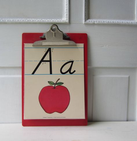 "You have your choice of vintage alphabet letter posters for home decor or crafts. 8\" x 10\", heavyweight poster board, laminated. The fronts feature illustrations while the backs show upper and lowercase handwriting diagrams (back shown in photo 5) Each  is in good vintage condition. The only flaws I noticed were pin holes in corners and some bent corners. Please see photos. Each will ship USPS First Class and arrive nicely packaged. More vintage typography here: https://www.etsy.com/shop/Thee School Work Display At Home, Vintage Classroom Decor Ideas, Classroom Decor Posters, Classic Classroom Decor, Vintage Classroom Aesthetic, Paper Organization Classroom, Vintage Classroom Theme, Antique Classroom, Cottagecore Classroom