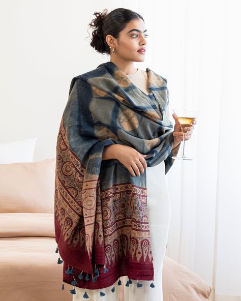 Drape your shoulders in the comforting warmth of traditional Indian artistry with this handwoven shawl from India. Crafted by local artisans from the westernmost frontier of India, this shawl is a symbol of understated luxury, encapsulating the culture and rich history of the region.  The hand-dyed natural fibers and the fineness of the weave don't just promise exceptional softness and resilience but reveal the extraordinary dexterity and skill of the Kutch people. As you run your fingers along Blue Shawl Outfit, Indian Scarf Outfit, Indian Shawl Outfit, Scarf Shawl Outfit, Indian Winter Wear For Women, Indian Inspired Outfits, Shawl Styling, Winter Kurti, Kurti Outfit