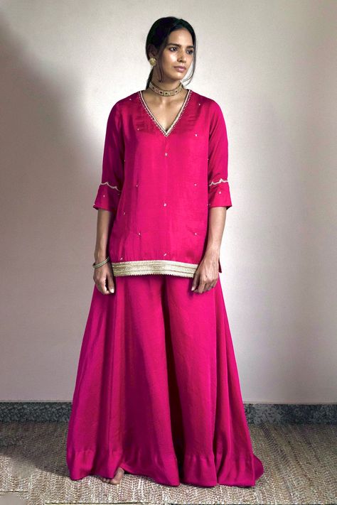 Hot pink kurta in silk satin base with floral embroidery and v neck. Paired with gharara.
Components: 2
Pattern: Embroidered
Type Of Work: Floral
Neckline: V neck
Sleeve Type: Three quarter
Fabric: Silk satin
Color: Pink
Other Details: 
Side slits
Attached lining
Note: The dupatta worn by the model is not for sale
Disclaimer: The fabric, color and texture of the final garment might have slight variations from the studio images and we use only handwoven fabrics
Occasion: Wedding - Aza Fashions Luxury Pink Dola Silk Kurta, Satin Kurta, V Neck Kurta, Handwoven Fabric, Silk Suit, Satin Color, Fashion App, Pink Silk, Set For Women