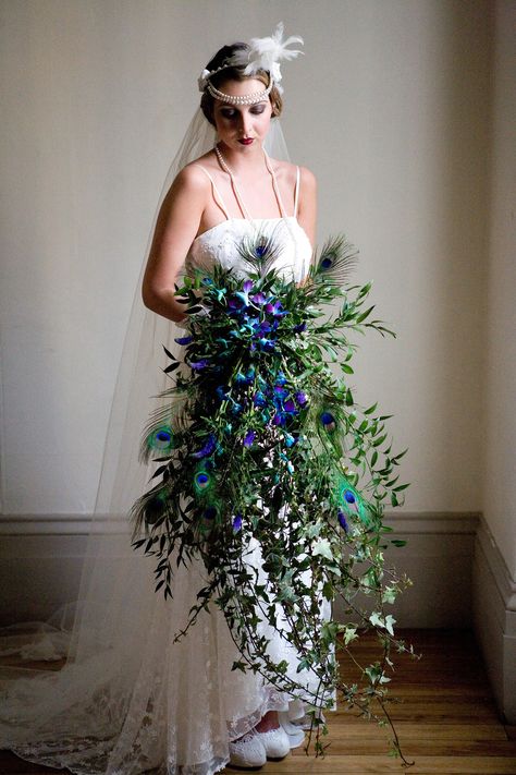 Downton Abbey 1920's style wedding bouquet. Wedding style bouquet. Great Gatsby wedding style http://www.blushrose.co.uk/manchester-wedding-florist/ Feather Bouquet, Holding A Bouquet, Peacock Wedding Theme, 1920s Wedding, Purple Wedding Flowers, Feather Wedding, Peacock Wedding, Gatsby Wedding, Lace Bridal Gown