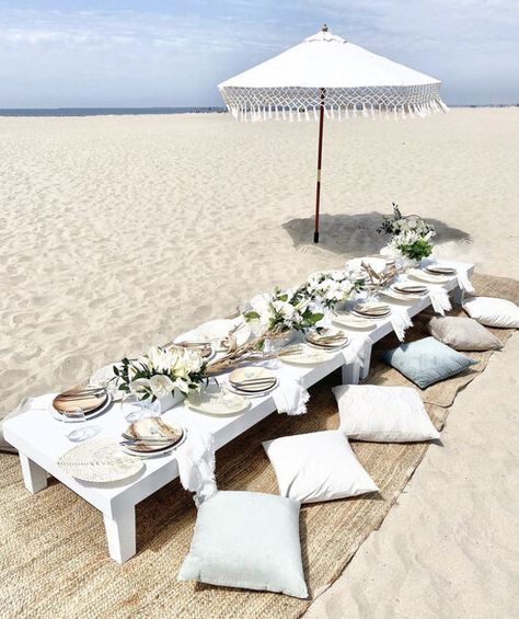 Huntington Beach Picnic, Newport Beach Picnic, Laguna Beach Picnic, Low floor table design, boho modern picnic, bamboo plate, rattan rug, rattan fan, picnic design, fringe umbrella, floor pillow seating, double long table design Beach Baby Shower Theme, Beach Baby Showers, Boho Birthday Party, Beach Dinner, Beach Birthday Party, Picnic Inspiration, Rustic Table Decor, Picnic Decorations, Picnic Birthday