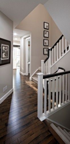 White banister poles with a dark wood handrail and matching stained floor make this space look brilliant, beige/grey walls are the perfect colour to complement the wood White Banister, Hallway Flooring, Floor Colors, Home Decor Online, Entry Way, Hardwood Flooring, Home Reno, Grey Walls, My Dream Home