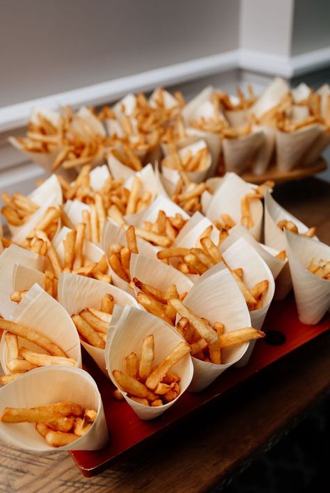 this french fry bar is set up with small paper cones of french fries, which are in boardwalk style french fry holders Party Snacks Wedding, Fries Bar Wedding, Fries At Wedding, Midnight Snack At Wedding, French Fry Wedding Bar, Reception Treat Ideas, Cocktail Wedding Food Ideas, Wedding Fast Food Bar, Wedding Food Late Night