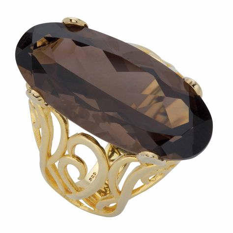 PRICES MAY VARY. Main Stone: 1 Oval Faceted Cut Genuine Smoky Topaz, 4.00 carats, 22 mm x 11 mm 14k Gold-Plated Sterling Silver; Contains 4.50 grams of Sterling Silver Measures: 21 mm wide x 26 mm long x 9.5 mm high; Shank Width: 3.0 mm wide Includes gift box and drawstring pouch Glam it up and shimmer like a star with this gorgeous cocktail ring. Featuring a huge genuine smoky topaz faceted oval stone, it sits atop an intricately designed scrolled shank for a glamorous presentation. Get ready f Mystic Fire Topaz, Faceted Ring, Smoky Topaz, White Topaz Rings, Gold Band Ring, Domed Ring, Oval Stone, Topaz Ring, Gold Plated Silver