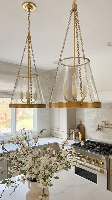 Michelle Riley | Design & DIY on Instagram: "Get this designer look for a fraction of the price! I can’t believe I found an almost identical look for less option for my pendant lights! Comment SHOP for the link to my designer pendants and the look for less pendants!" Pendant Above Kitchen Sink, Kitchen Pendant Lights Over Island, Kitchen Village, Designer Pendants, Above Kitchen Sink, Lights Over Island, Cherry Leaf, Coastal Kitchen Design, Glass Pendent