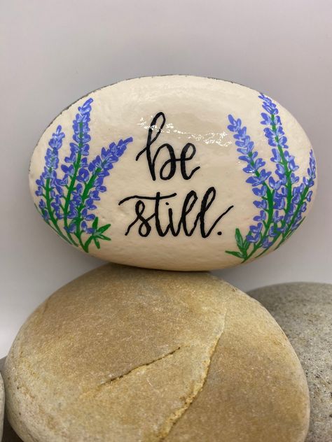 This hand-painted rock is a one-of-a-kind work of art. I use acrylic paint and all lettering and graphics are free-hand. The rock is protected with a sealant to make it suitable for indoor and outdoor purposes. Painted Rocks Outdoors, Faith Rocks Painting, Bible Rock Painting Ideas, Bible Verse Rocks, Bible Verse Rock Painting, Religious Painted Rocks, Christian Painted Rocks, Christian Rock Painting, Memorial Rocks Painted