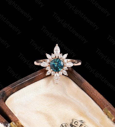 RING DESCRIPTION ✦Engagement Ring ✴Center Stone Round Cut - Teal Sapphire / Blue Moonstone / DEF Moissanite / Sunstone Size - 6mm ✴Side Stones Round Cut & Marquise Cut - Moissanite / Diamond Carat - approx 0.46 ct ✴Band Width - About 1.6mm ✴Ring Metal: Available in 14k/18k solid rose, yellow or white gold. ✦Find More Unique Art deco Rings： https://www.etsy.com/shop/TinyLightJewelry?section_id=36513259 CUSTOM SERVICE Our rings are customizable, including Special Ring Size Custom, CAD service, Gem Green Gem Stone Engagement Rings, Vintage Green Sapphire Ring, Peacock Sapphire Ring, Art Deco Engagement Ring Sapphire, Vintage Sapphire Engagement Rings, Teal Engagement Ring, Peacock Sapphire Engagement Ring, Sapphire Engagement Ring Round, Round Sapphire Engagement Ring