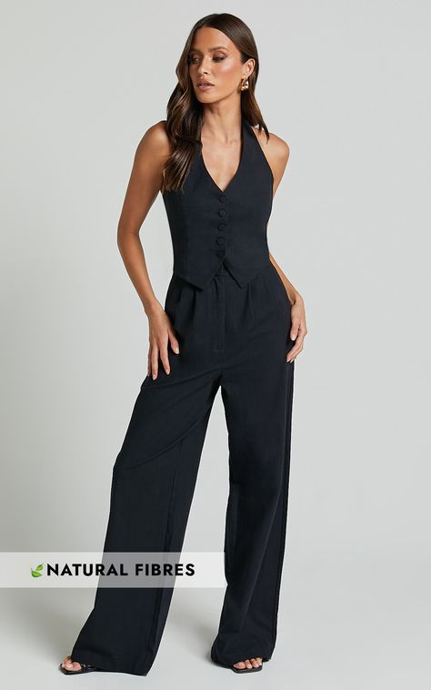 Get ready to turn heads in the Linette Jumpsuit! This playful and flirty black jumpsuit features a halter neck and sleeveless design, perfect for those warm summer days. Made from soft cotton fabric, this casual jumpsuit will keep you comfortable all day long. The button-through vest adds a touch of sophistication, while the tailored wide leg gives it a trendy look. Whether you're heading out with friends or attending a special event, this versatile jumpsuit is sure to make a statement. Don't mi Two Piece Jumpsuit Formal, Formal Vest Outfits For Women, Black Jumpsuit Outfit Casual, Black Formal Jumpsuit, Business Jumpsuit, Abi Ball, Sleeveless Jumpsuit Outfit, Wide Leg Jumpsuit Outfit, Women Jumpsuit Outfits