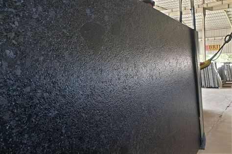 Rajasthan Black granite slab in leather finish This is the absolute best a black granite can feel. When you leather black granite from Rajasthan, you get the small indentations, you may otherwise not get on the hard South Indian Granite Rajasthan Black granites stay cooler for longer due to their porous nature as compared to Khammam black or absolute black granite. Rajasthan Black granite stands better quality to expand and contract without cracking in areas of extreme temperatures. Paneling Door, Leather Finish Granite, Black Kota Stone Flooring, Texture For Wall, Titanium Black Granite, Black Granite Leather Finish, Black Pearl Granite Leathered, Staircase Interior, Granite Texture