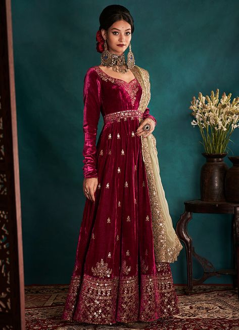 Dress to impress with this our Magenta and Gold Embroidered Velvet Anarkali.  The magenta velvet pishwas has been pleated with kashmiri style embroidered detailing of tilla and dabka in a scintillating shade of muted gold hue. The transition of small booties into big eloborate motives transcending into an abundantly wo Churidar Pajama, Indian Suits For Women, Heavy Dupatta, Short Frock, Pakistani Wedding Dresses, Anarkali Dress, Frock Design, Fashion Attire, Pakistani Bridal