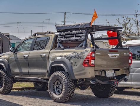 Toyota Hilux Overland-adventure build with Yakima Bed rack, ARB awning, and wide fender flares. See the full list of upgrades and read more about this awesome truck in our exclusive feature on Offroadium! Hilux Camping, Truck Overlanding, 4wd Setup, Toyota Hilux Offroad, Hilux Overland, Hilux Mods, Toyota Hilux 4x4, Toyota Offroad, Hilux 4x4