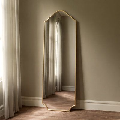 Dark with a bit of flair. This free standing, full length metal mirror provides a modern gothic aesthetic to your home! Perfect for bedrooms, dressing areas, and entryways - This tall beauty catches your body from head to toe so you can see your whole outfit with ease. Featuring an iron frame finished in a matte black to provide a timeless splash of dark style to any room its placed in! The dark finish encourages this mirror to blend in your home, while the touch of flair in the styling adds to Full Length Mirror On Closet Door, Living Room Full Length Mirror, Mirror Stand Decor, Hallway Mirror Ideas Full Length, Dressing Room Mirror Ideas, Tall Mirror In Bedroom, Full Length Mirror With Shelf, Vintage Standing Mirror, Gold Full Length Mirror