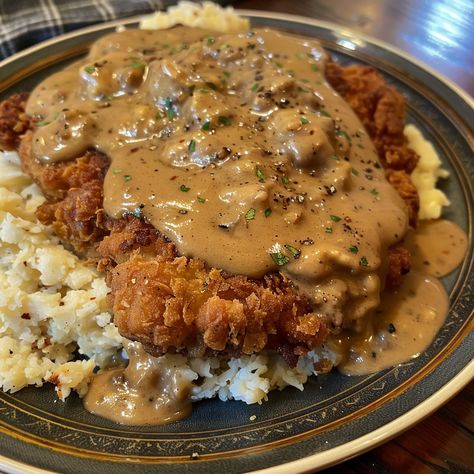 🥩🍴 Dive into the comfort of Chicken Fried Steak with creamy gravy! A true Southern delight. #ComfortFood #ChickenFriedSteak Chicken Fried Steak with Gravy Recipe Savor the crispy coating and tender steak, smothered in a rich, creamy gravy for a classic Southern meal. Ingredients: Beef cube steaks: 4 (about 600g total) All-purpose flour: 150g Eggs, beaten: 2 Milk: 120ml for batter + 240ml for gravy Salt: 5g Ground black pepper: 5g Garlic powder: 5g Vegetable oil for frying Butter: 30g Chic... Chicken Fried Steak And Eggs, Country Fried Chicken And Gravy, Biscuits And Gravy Recipe, Steak With Gravy, Cube Steaks, Steak And Gravy, Southern Dinner, Country Fried Steak, Tender Steak