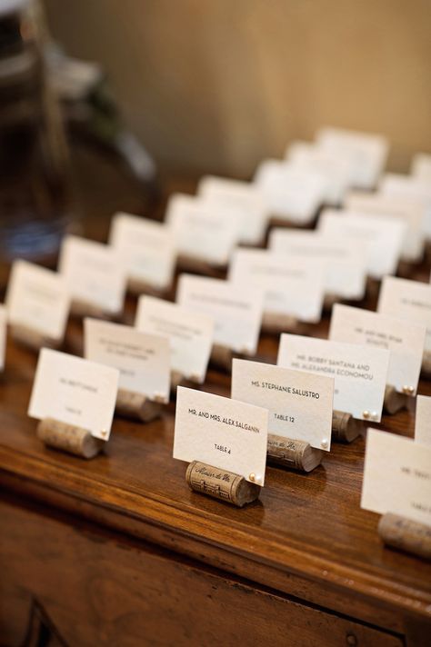 Even the most caring, invested wedding guest looks forward to the reception… Wine Cork Centerpiece, Wine Cork Place Card Holders, Cork Place Cards, Cork Place Card Holders, Wine Cork Table, Greek Wedding Candles, Wine Cork Place Card Holder, Wine Cork Wedding, Cork Wedding