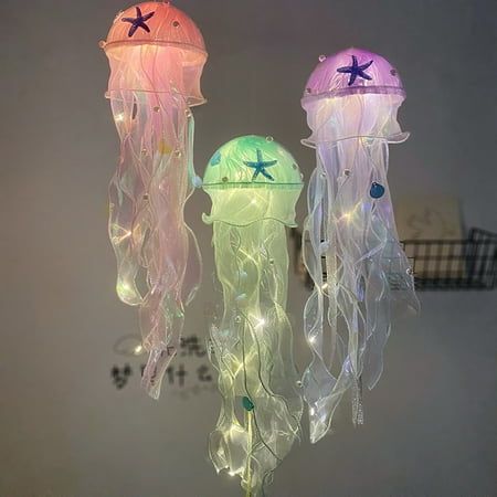 Description: By creating a soothing and relaxing environment, this night light will help you and your child fall asleep. You can use this Jellyfish decor light to light up your home and create a romantic ambiance, and this light is an ideal eye catching to your home or party decoration and makes the simple life more colors and interesting. It is made of high-quality acrylic and yarn material. The length of this product is 50cm and width is 12cm. It is widely used in bar, club, restaurant, park, Night Lamp Aesthetic, Jellyfish Lights, Astronaut Light, Jellyfish Decor, Floating Jellyfish, Glowing Jellyfish, Jellyfish Decorations, Calm Aesthetic, Gentle Movement