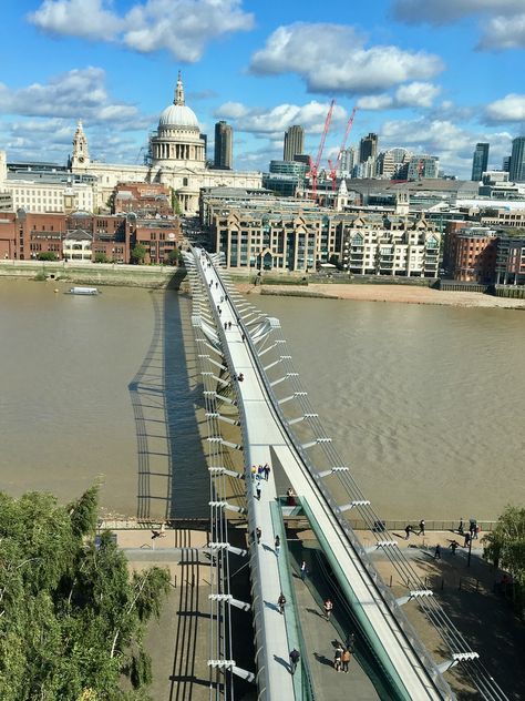 Take in a view of London's Millennium Footbridge, also known as The Wibbly Wobbly Bridge. It spans the River Thames, connecting the Tate Modern Art Gallery to Saint Paul’s Cathedral, two of London’s most recognizable landmarks. For more insight on this iconic footbridge, which first opened on 10 June 2000, check out this blog post written by Blue Badge Tourist Guide Edwin Lerner. https://www.guidelondon.org.uk/blog/around-london/london-millennium-footbridge/ 📸 Ursula Petula Barzey. #BlueBadg... Tate Modern Museum, St. Paul’s Cathedral, The Tate Modern, Tate Modern Art, Tour Manager, Modern Art Gallery, Initial Design, Tourist Guide, Pedestrian Bridge