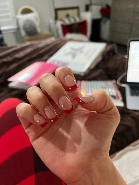 Red Tip Nails With Rhinestones, Dark Red French Tip Nails With Gems, French Tip With Red Accent, Red French With Diamonds, Neon Red French Tip Nails, Red French Tip Nails Almond With Rhinestones, Red Glitter French Tip Nails Short, Red French Tips With Pearls, Red French Tip Nails With Diamonds