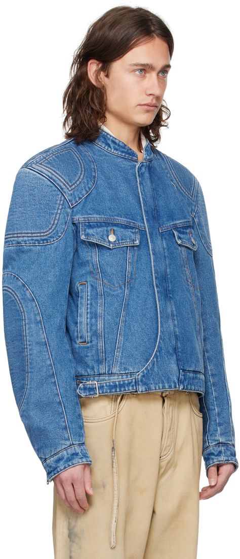 Non-stretch denim jacket. Fading and reinforced panels throughout. · Paneled construction · Band collar · Two-way zip closure with press-stud placket · Flap and zip pockets · Adjustable cinch strap at cropped hem · Padded shoulders and elbows · Zip vent at cuffs · Suede logo patch at back hem · Adjustable button tabs at back hem · Welt pocket at interior · Full twill lining · Contrast stitching in tan Supplier color: Mid blue Biker Denim Jacket, Futuristic Jacket, Denim Biker Jacket, Designer Denim Jacket, Panel Jacket, Mens Fashion Denim, Biker Denim, Denim Ideas, Mens Fashion Jeans