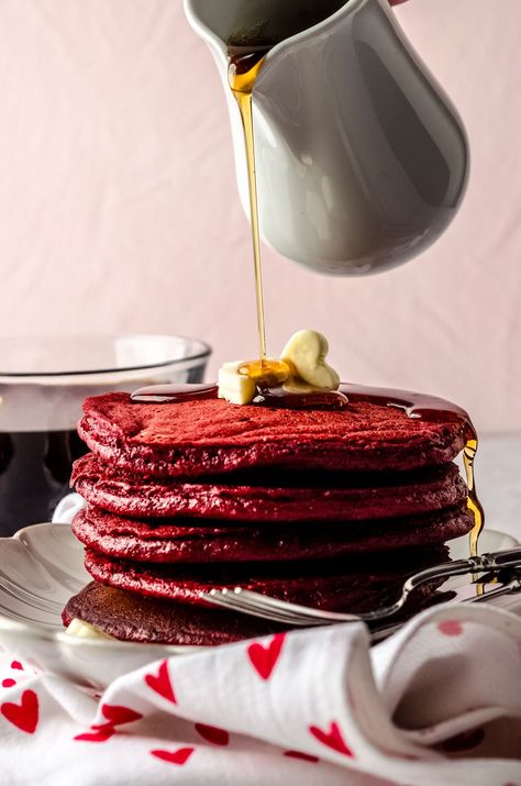 This red velvet pancake recipe starts with a red velvet cake mix to produce perfectly light and fluffy pancakes. Serve with traditional maple syrup, homemade whipped cream, or tangy cream cheese frosting for a fun Valentine's Day breakfast recipe or Valentine's Day brunch recipe. | red velvet pancakes with cake mix simple | how to make red velvet pancakes recipe | valentines day breakfast ideas | valentines day brunch recipes Valentines Day Breakfast Ideas, Red Velvet Pancake, Valentines Day Brunch, Valentines Day Breakfast, Cake Mix Pancakes, Cinnamon Streusel Coffee Cake, Cake Batter Dip, Red Velvet Pancakes, Light And Fluffy Pancakes