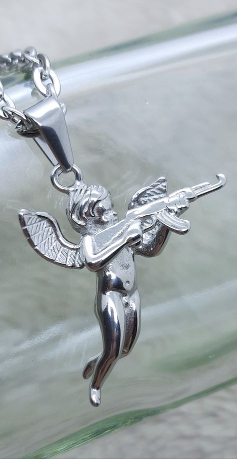 Cupid with gun pendant necklace. Angel and gun necklace. Beautiful and unusual pendant with polished silver finish. Suitable for everyday casual wear. Best quality 316 stainless steel. Lobster claw clasp. Great accessory for men or women.
#cupidnecklace #angelwithgunpendant #necklacesforwomen #naughtycupidnecklace #giftsforwomen #snowstarpendants Bad Angel, Popular Necklaces, Music Jewelry, Vintage Necklaces, Mens Pendant, Necklaces For Women, Lookbook Outfits, Vintage Necklace, Lobster Claw