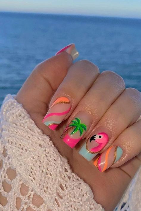 Embrace the tropical vibes with these almond-shaped summer vacation nails. A playful pink base is accented with a charming flamingo design, bringing a splash of vibrant personality. Swirling stripes of hot pink, pastel blue, and shining gold elegantly wrap across other nails, enhanced by a soothing palm tree motif that whispers the promise of relaxing beach days. The combination of pastels and lively hues make for a perfect summertime accessory. Beachy and chic! 🌴🦩  // Photo Credit: Instagram @nailsbykatyrose Tropical Holiday Nails Summer, Nail Art Designs Palm Trees, Lilly Pulitzer Nails Designs, Tropical Nails French Tips, Christmas In Hawaii Nails, Palm Tree Design Nails, Love Island Nails, Hot Summer Nails 2024, Margaritaville Nails