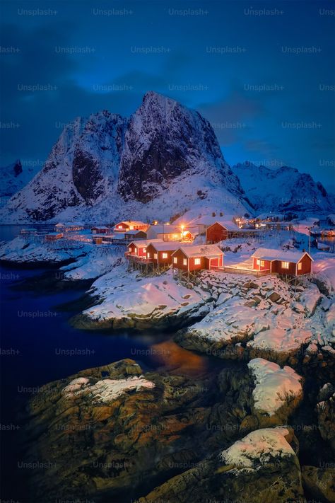 Famous tourist attraction Hamnoy fishing village on Lofoten Islands, Norway with red rorbu houses in winter snow illuminated in the evening photo – Norway Image on Unsplash Winter Norway, Lofoten Islands Norway, Evening Photo, Norway Winter, Christmas City, Lofoten Islands, Winter Images, Famous Places, Fishing Villages