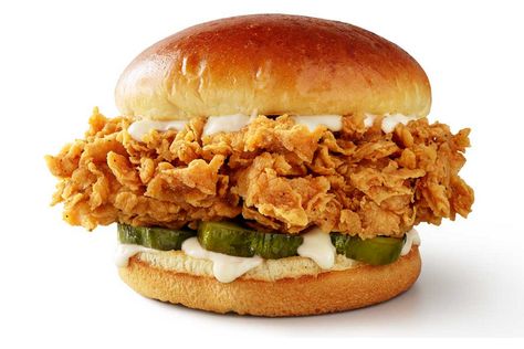 At select locations in Florida, KFC is offering a new sandwich item that's been touted as their best sandwich yet.  The new sandwich boasts a double-breaded extra crispy chicken filet that's 20 percent bigger than the Original Colonel Chicken Sandwich. In comparison, the premium is laden with crispier and thicker pickles, the Colonel's real mayo, and served on a brioche bun. You can get the sandwich in both classic or spicy,  depending on your affinity for heat. Chicken Filet, Crispy Chicken Sandwiches, Southern Chicken, Mall Food Court, Popeyes Chicken, Brioche Bun, Kfc Chicken, Fast Food Items, Buffalo Wild Wings