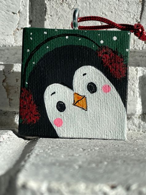 "-Unique keepsake gift or stocking stuffer!  -Wrapped in rustic Holiday style and ready for gift giving.  Original, Hand Painted Canvas Christmas Ornament - Penguin in Earmuffs - Original Art, Gifts,  & Home Decor A happy, adorable penguin sporting red ear muffs and a smile....perfect for Winter or Christmas. This ornament is one of a kind, hand painted and signed.  It is the first in my series of 4 penguins.  It would look lovely on a Christmas tree, on a festive wreath or as a unique gift topp