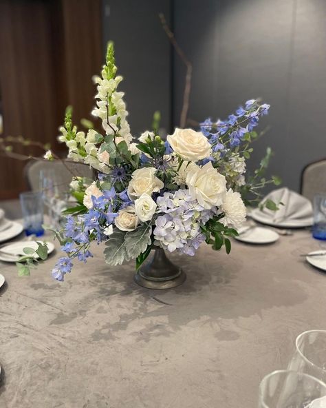 Inspo for April Showers! ☔️🎀✨🪷🫧🌊🪻🪴 Hydrangea And Delphinium Centerpiece, Blue And Green Centerpieces Wedding, Centerpieces Wedding Blue And White, Blue Green Flower Arrangements, Graduation Party Floral Centerpieces, Coastal Centerpiece Ideas Wedding, Blue And White Flower Centerpieces, Blue Centerpieces Wedding, Purple Floral Centerpieces