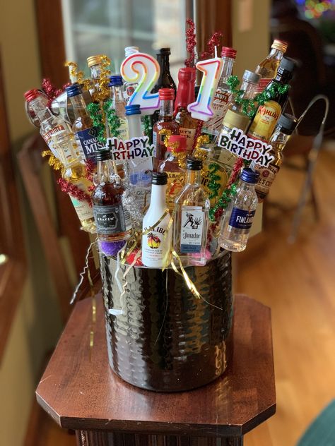 This bouquet is made of 21 single serving liquor bottles in an ice bucket. #21st birthday, #AlcoholTower, #mini alcohol bottles #miniliquorbottlebouquet 21st Birthday Ideas Guys Turning 21, 21st Birthday Ideas Guys, Happy 21 Birthday, 21st Birthday Basket, Booze Gift, Beer Cakes, 21st Birthday Ideas, To My Niece, 21st Birthday Presents