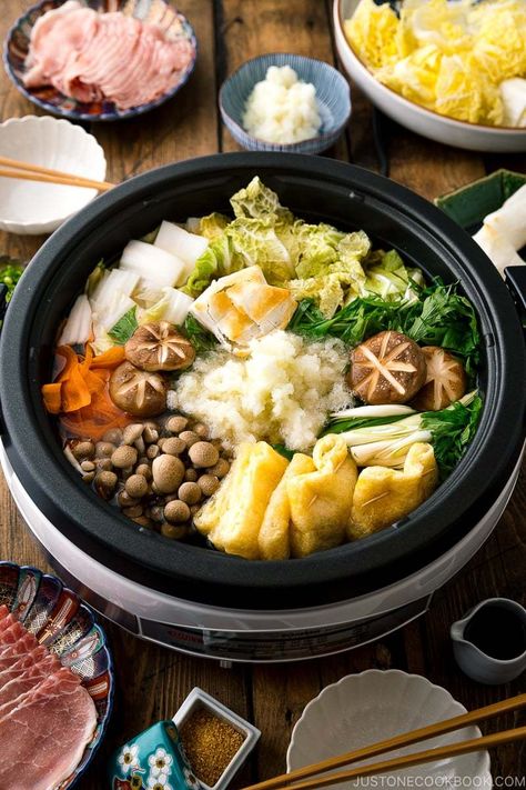 With napa cabbage, fried tofu, mushrooms, and mochi simmered in kombu dashi, Mizore Nabe is a Japanese hot pot cooked with grated daikon. The white radish resembles the winter sleet (mizore in Japanese) of which the hot pot gets its name. A perfect meal to warm up in the winter! #mizorenabe #hot pot | Easy Japanese Recipes at JustOneCookbook Daikon Recipes, Pickled Daikon Recipe, Kombu Dashi, Cabbage Fried, Daikon Recipe, Japanese Hot Pot, Slow Cooker Chicken Wings, White Radish, Deep Fried Tofu