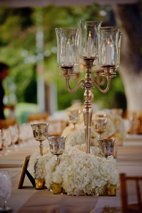 Medium centerpiece idea: silver candelabra with taper candles surrounded by mercury glass goblets filled with white hydrangeas and mercury glass votives. Tall Candles, Gold Candelabra, Candelabra Wedding, Silver Candelabra, Flowers And Candles, Candlestick Centerpiece, Candelabra Centerpiece, Nola Wedding, Idea Photo