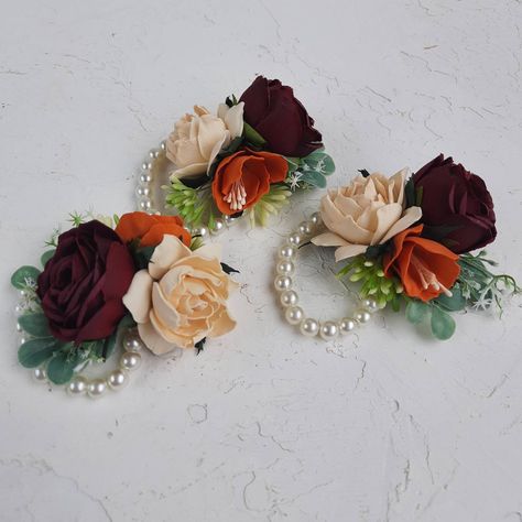 This corsage with burgundy champagne orange fake roses will be perfect your fall wedding party. Created with handmade rusty burnt orange and ivory, burgundy roses.  The corsage comes as a artificial pearls wrist corsage. PLEASE FELL FREE TO MESSAGE ME IF YOU HAVE ANY QUESTION Orange Wrist Corsage, Floral Boutonniere, Orange Champagne, Wrist Corsage Wedding, Fall Wedding Hairstyles, Bridesmaid Corsage, Rustic Boutonniere, Burnt Orange Weddings, Corsage Prom