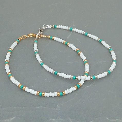 This white turquoise seed bead anklet has been lovingly made using 3mm white and turquoise Preciosa seed beads.  With 3mm Miyuki highlighting beads in either silver or gold. Threaded on strong stainless steel 7 strand Tiger Tail wire and finished with silver/gold plated wire guardians and a lobster clasp, making it easy to put on & take off. With an optional 2" Silver/gold plated extender chain so you can wear the anklet to sit where you feel most comfortable. Matching necklace and or Bracelet a Cute Necklace Ideas Beads, Cute Beach Necklaces, White And Gold Beaded Bracelet, Aesthetic Seed Bead Bracelets, Anklet Bead Ideas, Diy Seed Bead Bracelet Ideas, Seed Bead Anklet Ideas, Sea Bead Bracelets Ideas, Seed Beads Bracelets Ideas