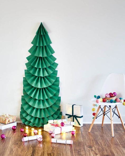 Create a life-size 2-D folded paper tree this Christmas. It's a sweet way to make your own tree when you're short on space or on a tight budget. Cardboard Tree Christmas, Paper Tree Bulletin Board, 3d Christmas Tree Bulletin Board, Paper Christmas Tree On Wall, Christmas Tree On Wall, Tree On Wall, Swim 2023, Diy Paper Christmas Tree, Junior Ranger