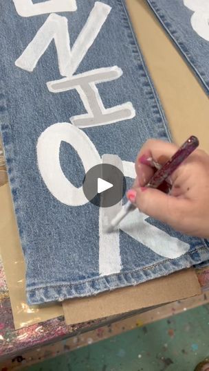 Painted jeans | Do you want to see me paint the back side too? | By Wayward WhimsyFacebook Homecoming Painted Jeans Ideas Diy, Diy Jean Designs Paint, How To Paint Denim, Hand Painted Jeans Pants, Hand Painted Jeans Ideas, Painted Pants Design, Painted Jean Jacket Diy, How To Paint On Jeans, Painting On Jeans Ideas