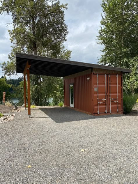 This shipping container carport provides storage and a parking space. It can be delivered to Oregon & Washington. Shipping Container With Carport, Shipping Container Carport Garage, Roof Over Shipping Container, Storage Container Office Ideas, Shipping Container For Storage, Storage Container Shop Ideas, Rv Covered Parking Carport Designs, Shipping Container Garage Ideas, Shipping Container Shop Ideas