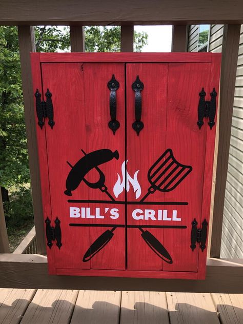 Upgrade your outdoor grill station with a beautiful and functional DIY grill tools organizer and storage cabinet. This cabinet is simple to make and is an easy weekend project. This cabinet features double doors with magnetic catches and holds 4 grill tools. I sized it at 15.5” wide and 19.5“ tall on the interior to fit our BBQ tools. You can easily adjust the size to fit your tools. Decorated with a cool vinyl graphic. Bbq Utensil Storage, Bbq Tools Storage, Utensils Holder Diy, Bbq Utensil Holder, Tool Wall Storage, Grill Accessories Storage, Diy Utensils, Tools Organizer, Easy Weekend Projects