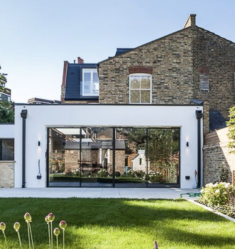 Modern rear extension, glass sliding doors, black rainwater pipe, metal capping along top of the extension's roof Modern Rear Extension, Modern Flat Roof Extension, Double Storey Extension, Terrace House Extension, Contemporary Extension, Flat Roof Extension, Single Storey Extension, House Contemporary, Extension Plans