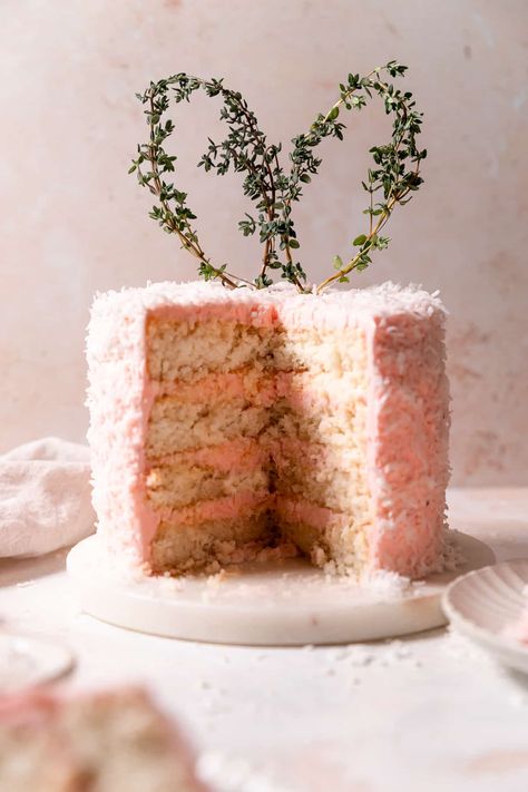 This Easter coconut cake is packed with coconut flavor and has a moist crumb, coconut frosting, and cute thyme bunny ears on top! Easter Coconut Cake, Cambrea Bakes, Easter Meal, Coconut Frosting, Layer Cake Recipes, Easter Desserts, Crumble Bars, Pink Food Coloring, Berries Recipes