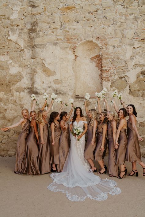 Bridal party photos at the San Juan Capistrano Mission Toupe Bridesmaid Dresses, Country Wedding Maid Of Honor Dresses, Sage And Tan Bridal Party, Gold Brown Bridesmaid Dresses, Coffee Color Wedding Theme, Taupe Brown Bridesmaid Dresses, All Tan Wedding Party, Black Bridesmaid Dresses With Tan Suits, Earthy Bridal Party