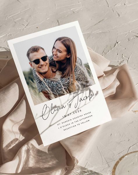 Make your wedding announcement a snap! The Olivia Wedding Invitation features a playful polaroid design, perfect for showcasing a cherished photo and setting a fun and personal tone for your celebration. Key Features: DIGITAL TEMPLATE VERSION AVAILABLE ON OUR SITE Customisable colors and details High-quality paper and printing Perfect for a traditional or vintage-inspired wedding Let ourinvitations set the tone for your elegant celebration. Order yours today! Frequently Asked Questions: How do I personalise? Either add you personalisation to the box provided or send us a message. How do I add more cards? To upgrade your invitations from a single card or pack, please see our site. What is a 3 Card pack?  A Pack will consist of An A5 Card, A6 Card And 100mm Square Card With Teardrop Papercli Polaroid Photo Wedding, Polaroid Design, Gold Wedding Stationery, Polaroid Wedding, Elopement Invitation, Unique Wedding Stationery, Polaroid Picture, Polaroid Photo, Photo Wedding Invitations