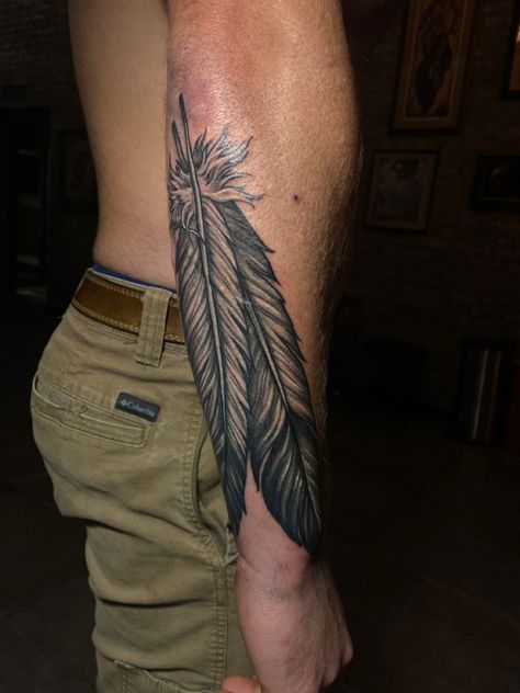 Mens Feather Tattoo Forearm, Mens Native Tattoos, Men Feather Tattoo Ideas, Country Neck Tattoo, Warrior Feather Tattoo, Indian Arm Tattoo, Western Feather Tattoo Men, Folded Flag Tattoo, Western Tattoos For Men Country