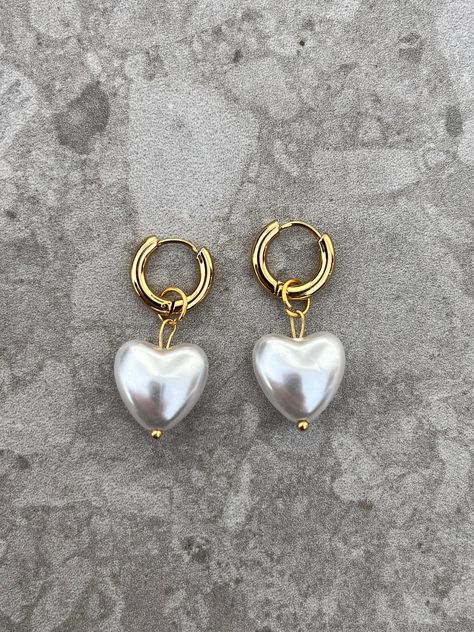 Introducing our captivating gold-colored earrings embellished with a heart-shaped pearl bead! These elegant beauties are the perfect addition to any jewelry collection. Handcrafted with care, they radiate a timeless charm that effortlessly complements any look. The lustrous gold finish adds a touch of sophistication, while the delicate heart pearl bead serves as a symbol of love and affection. Whether you're dressing up for a special occasion or simply want to add a touch of elegance to your eve Boho Rings Gold, Chainmail Bracelet, Colored Earrings, Gold Mandala, Color Earrings, Love And Affection, Love Shape, Silver Chain Bracelet, Silver Bangles