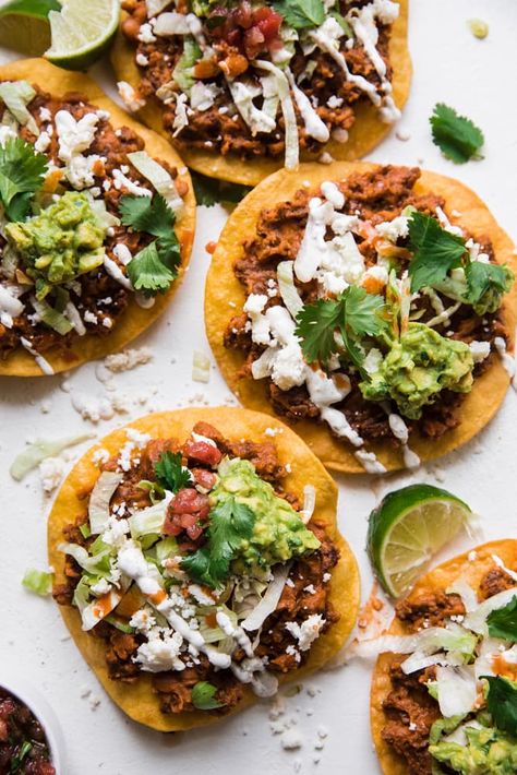 Crispy store-bought tostada shells and canned refried beans make this chorizo tostada recipe a total cinch! Quick, delicious and oh-so-good. Canned Refried Beans, Tostada Shells, Southwestern Food, Tostada Recipe, Guacamole Chips, Seasoned Sour Cream, Canning Refried Beans, Tostada Recipes, Raw Pork